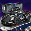 A black 1:14 scale RC sports car building kit is displayed next to its components and a remote control device.