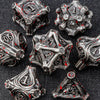 A collection of intricate, metallic dice made from zinc alloy, featuring a dark silver finish and red accents.