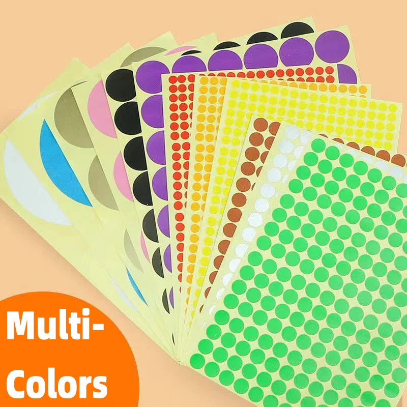 A stack of round self-adhesive dot labels in various colors and sizes, including yellow, pink, black, orange, and green.
