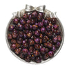 A pile of dark purple and brown glitter cat eye resin beads in a silver dish for jewelry making