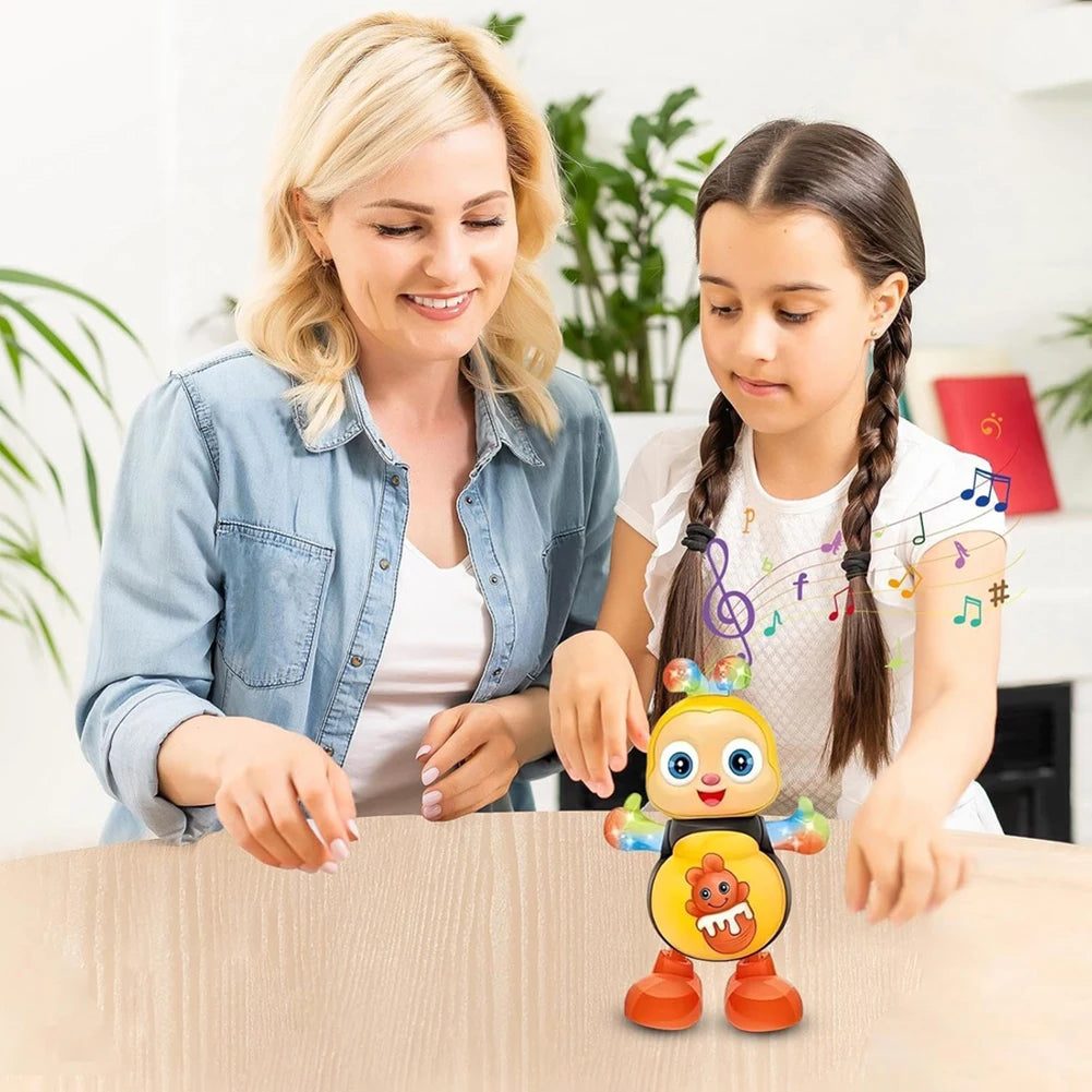 A woman and a girl are looking at an electric dancing bee musical toy on a wooden table.