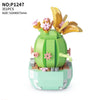 A green cactus building block set featuring a floral bouquet made of pink and yellow flower pieces.