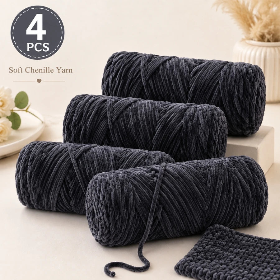 Four skeins of dark gray soft chenille yarn for crochet and knitting projects.