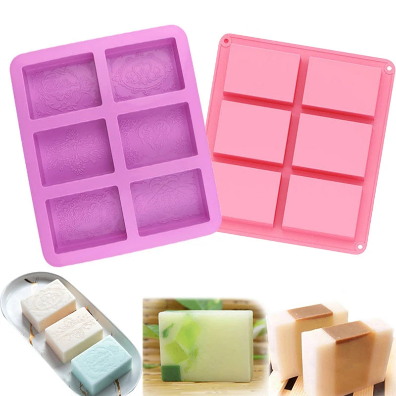 Pink and purple silicone soap molds with six square cavities and several finished bars of handmade soap.