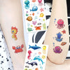 A collection of colorful glitter mermaid and underwater sea creature temporary tattoos on an arm.
