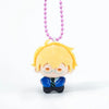 A yellow-haired chibi plush charm with glasses and a blue shirt, hanging from a purple beaded necklace.