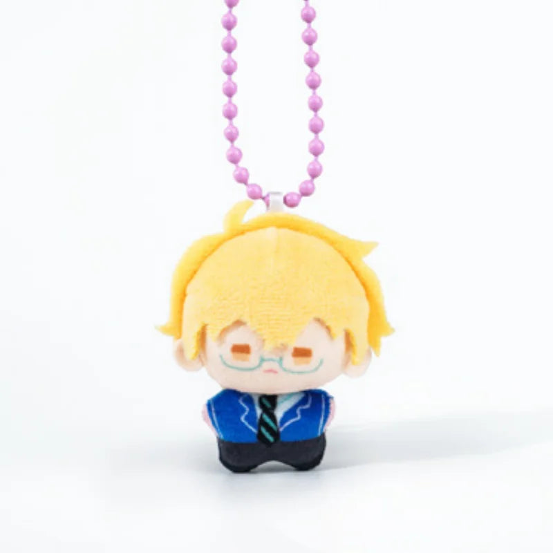 A yellow-haired chibi plush charm with glasses and a blue shirt, hanging from a purple beaded necklace.