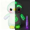 A plush penguin toy split vertically, showing a white side and a green glowing side.
