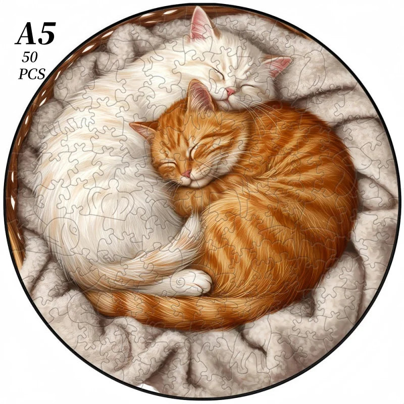 A jigsaw puzzle depicting two sleeping cats, one white and one orange, nestled together.