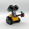 A yellow and gray building block vehicle with large binoculars and a green antenna.