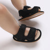 Black breathable first walker sandals for baby with a soft sole and hook-and-loop closure