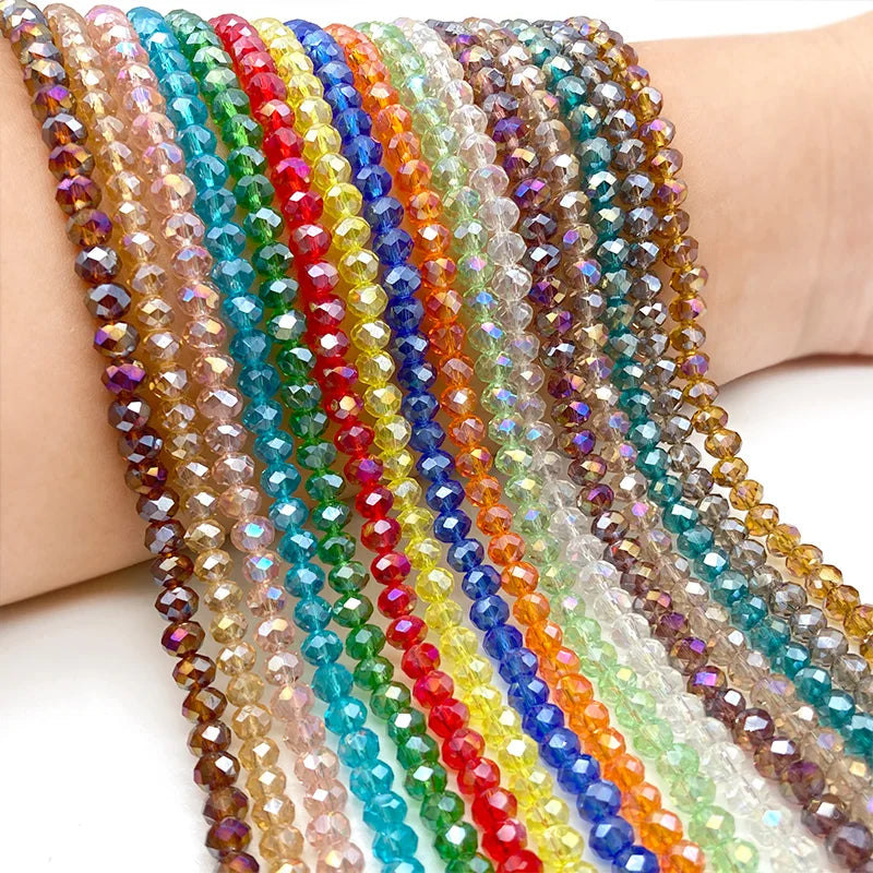 A close-up of multicolored faceted crystal beads strung together on a bracelet or string.