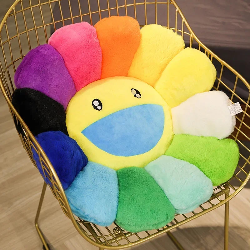 A collection of colorful, round sunflower-shaped plush cushions in various shades of yellow, orange, pink, purple, and blue d