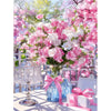 A bouquet of pink and white flowers displayed in a glass vase on a table.