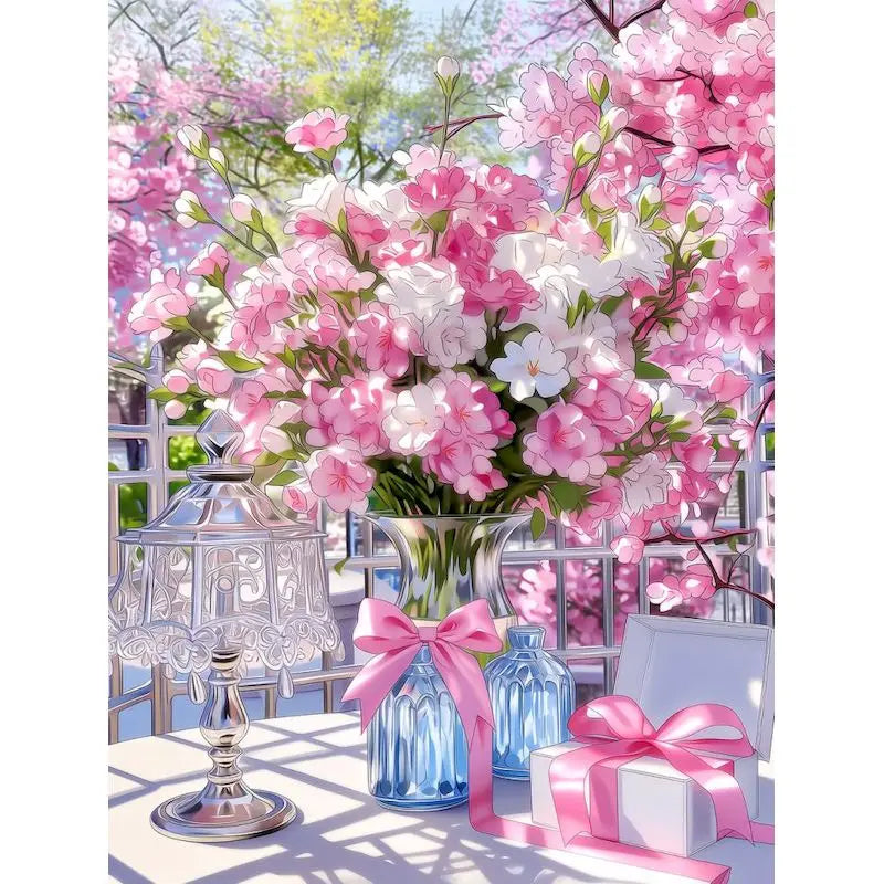 A bouquet of pink and white flowers displayed in a glass vase on a table.