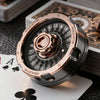 A close-up shot of a rose gold metal D20 lucky roulette fidget spinner resting on playing cards.