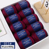 Box of ten skeins of deep red merino wool yarn with labels indicating worsted wool thread