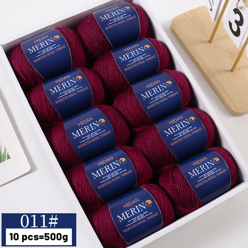 Box of ten skeins of deep red merino wool yarn with labels indicating worsted wool thread