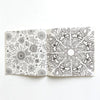 An open 24-page mandala coloring book featuring intricate black and white floral and swirling patterns.