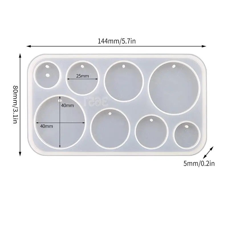 A white silicone mold set with multiple circular cavities for making epoxy resin earrings and pendants.