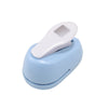 A light blue lever action embosser tool with a white embossing plate is shown on a white background.