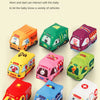 Multiple soft fabric toy cars for babies, including a yellow, green, pink, and red vehicle, displayed on a light background.