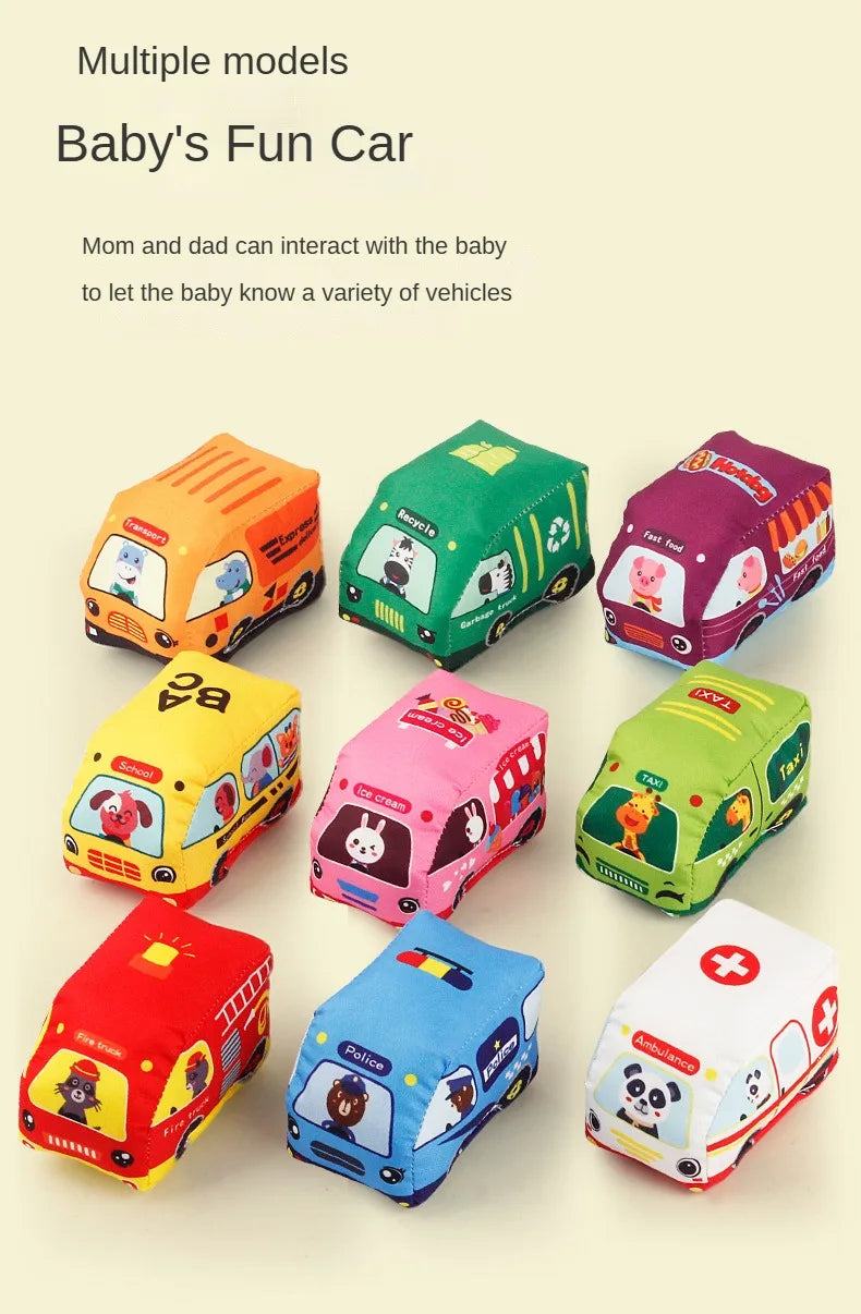 Multiple soft fabric toy cars for babies, including a yellow, green, pink, and red vehicle, displayed on a light background.
