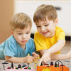 A toddler is interacting with a pink busy board featuring various switches and components for physics learning.