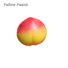 A squishy stress ball shaped like a peach, featuring a gradient of yellow and pink colors.