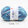 A ball of multi-colored yarn featuring shades of blue and gray, labeled as Jane cotton yarn.