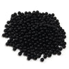 A pile of small, round, black imitation pearl beads for jewelry making.