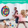 A family playing an interactive sticky ball dart game with a toddler on a floor.