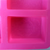 A square pink silicone mold with six cavities featuring an ornate floral pattern for DIY soap making.
