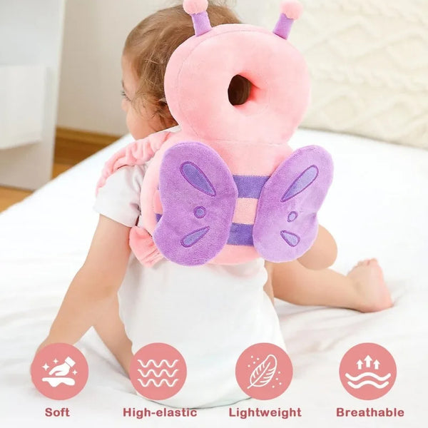 A toddler is wearing a pink and purple safety head protector backpack cushion on a white sheet.
