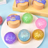 A collection of colorful glitter squishy buns and fidget toys displayed on a white plate.
