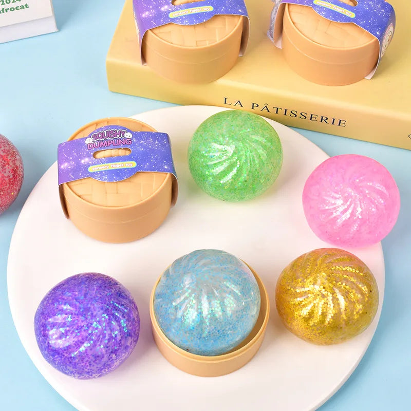 A collection of colorful glitter squishy buns and fidget toys displayed on a white plate.
