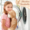 A girl holds a classic 14 inch plush teddy bear next to a washing machine, demonstrating the product's washable feature.