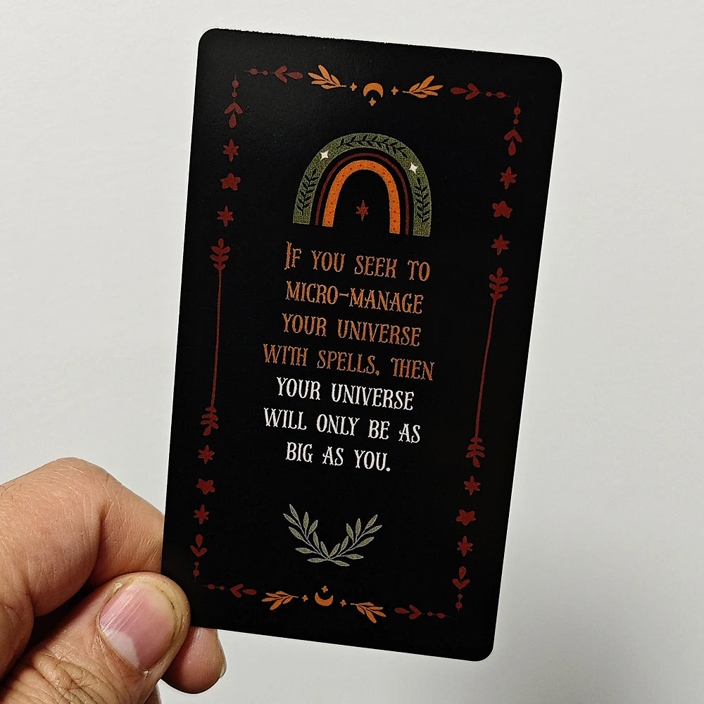 A black card featuring an arched rainbow design and text about micro-managing the universe with spells