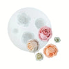 A white silicone mold tray featuring several pink and peach colored rose-shaped molds for crafting or aromatherapy.