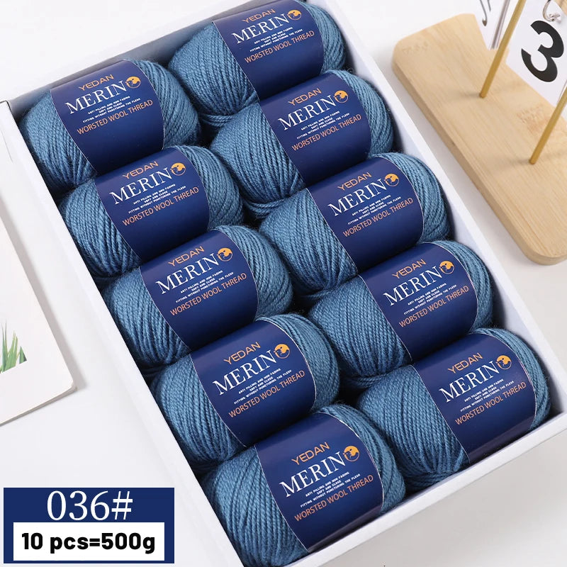 A box of YEDAN MERIN worsted wool thread yarn in blue and gray colors for knitting projects