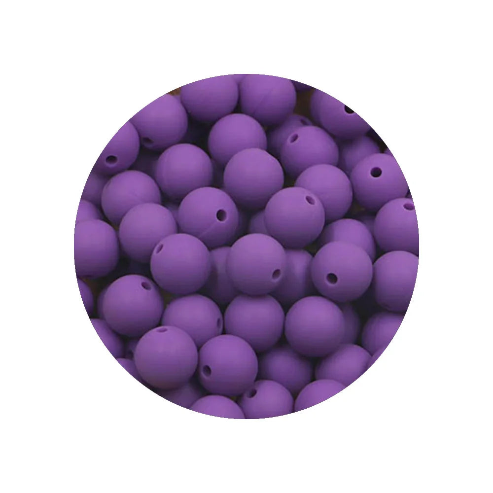 A close-up view of a pile of purple silicone beads for DIY jewelry making