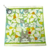 A soft stuffed animal featuring a cute gray cat design on a light green fabric.