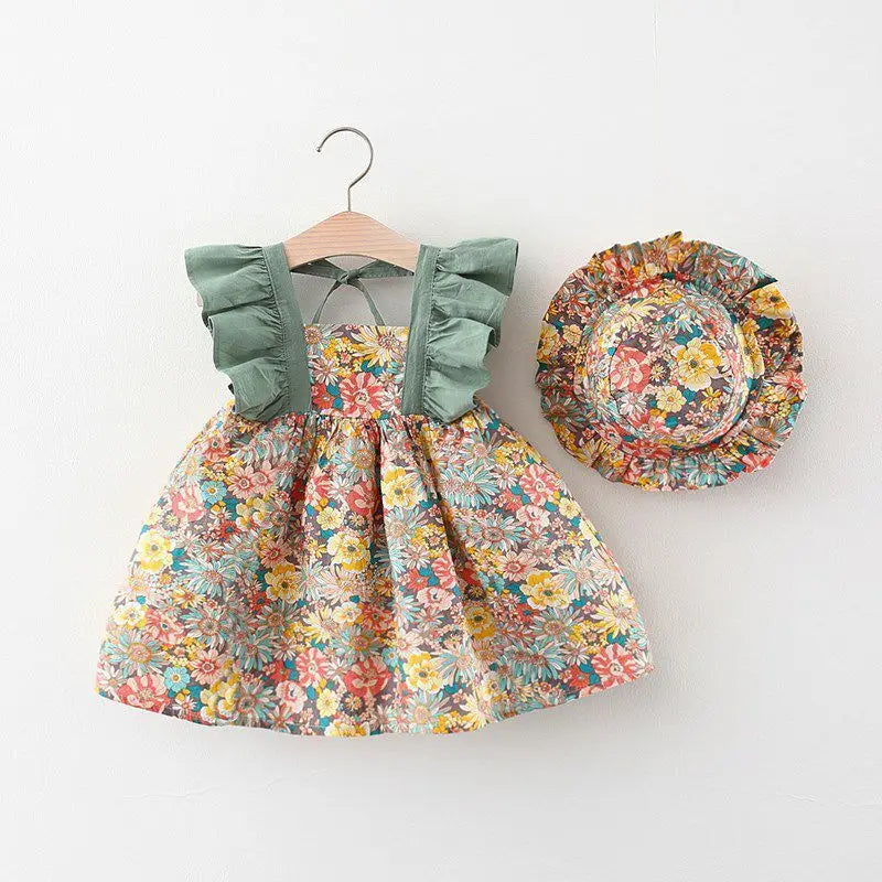 A floral summer dress for a baby girl with ruffled sleeves and a matching sunhat displayed on a hanger.