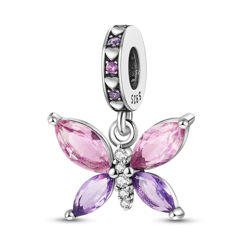 A silver heart charm bead featuring pink zircon stones and a detailed butterfly design.