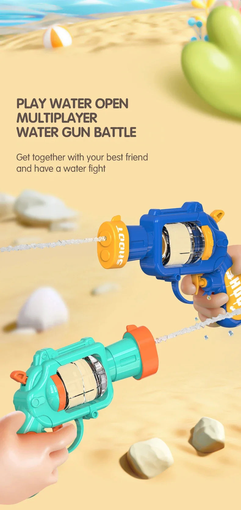 A hand holds a blue water gun and a teal water gun firing water at a sandy beach background.