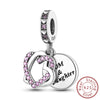 A sterling silver heart charm bead with pink stones and a tag engraved with Mom & Daughter