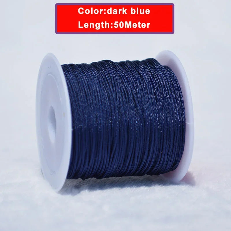 A spool of dark blue 0.8mm nylon knotting cord for jewelry making with a 50-meter length.