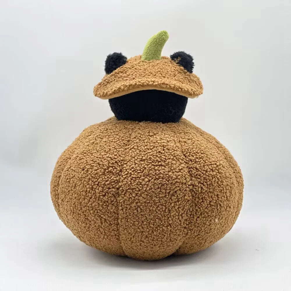 A fluffy brown cat plush pillow with black ears and a green nose.