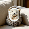 A fluffy, light brown and white hedgehog plush pillow resting on a beige sofa.