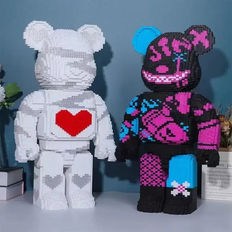 A white and black building block model of a bear and a pink and black striped monster bear are displayed side by side.